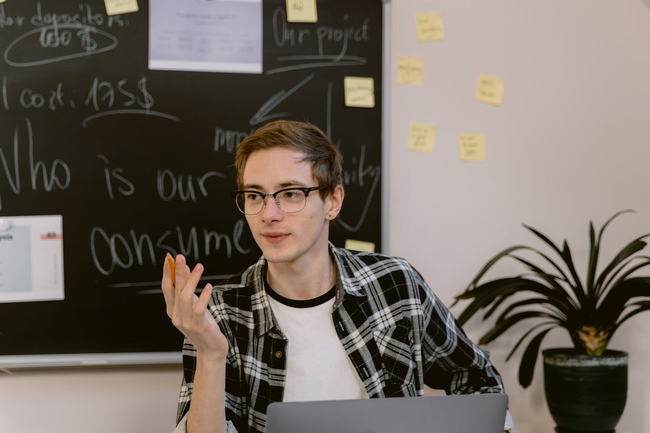 Man in Black and White Plaid Dress Shirt Wearing Eyeglasses